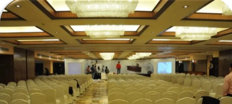 A corporate customer meet in progress, with guests seated and the stage in use.